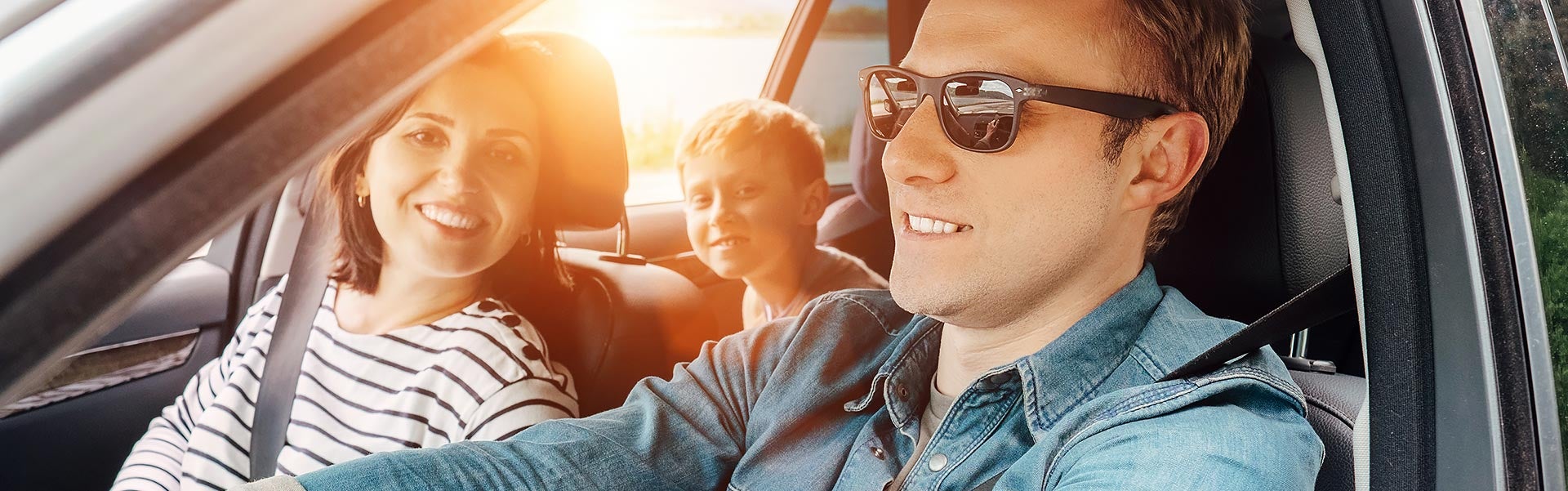 A happy family on a road trip in a GMC SUV.